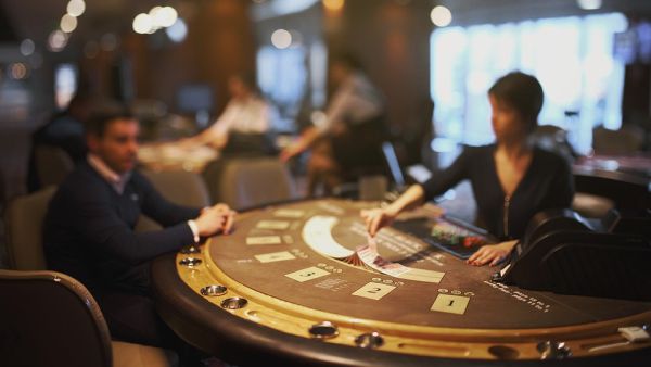 A player and a dealer at a blackjack table A player and a dealer at a blackjack table