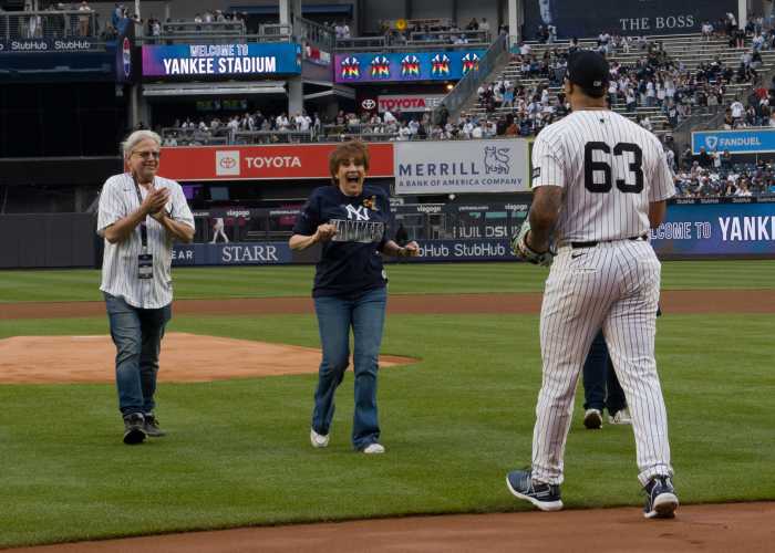 Lorna Luft reacts after throwing out the first pitch to Yankees' pitcher Fernando Cruz.