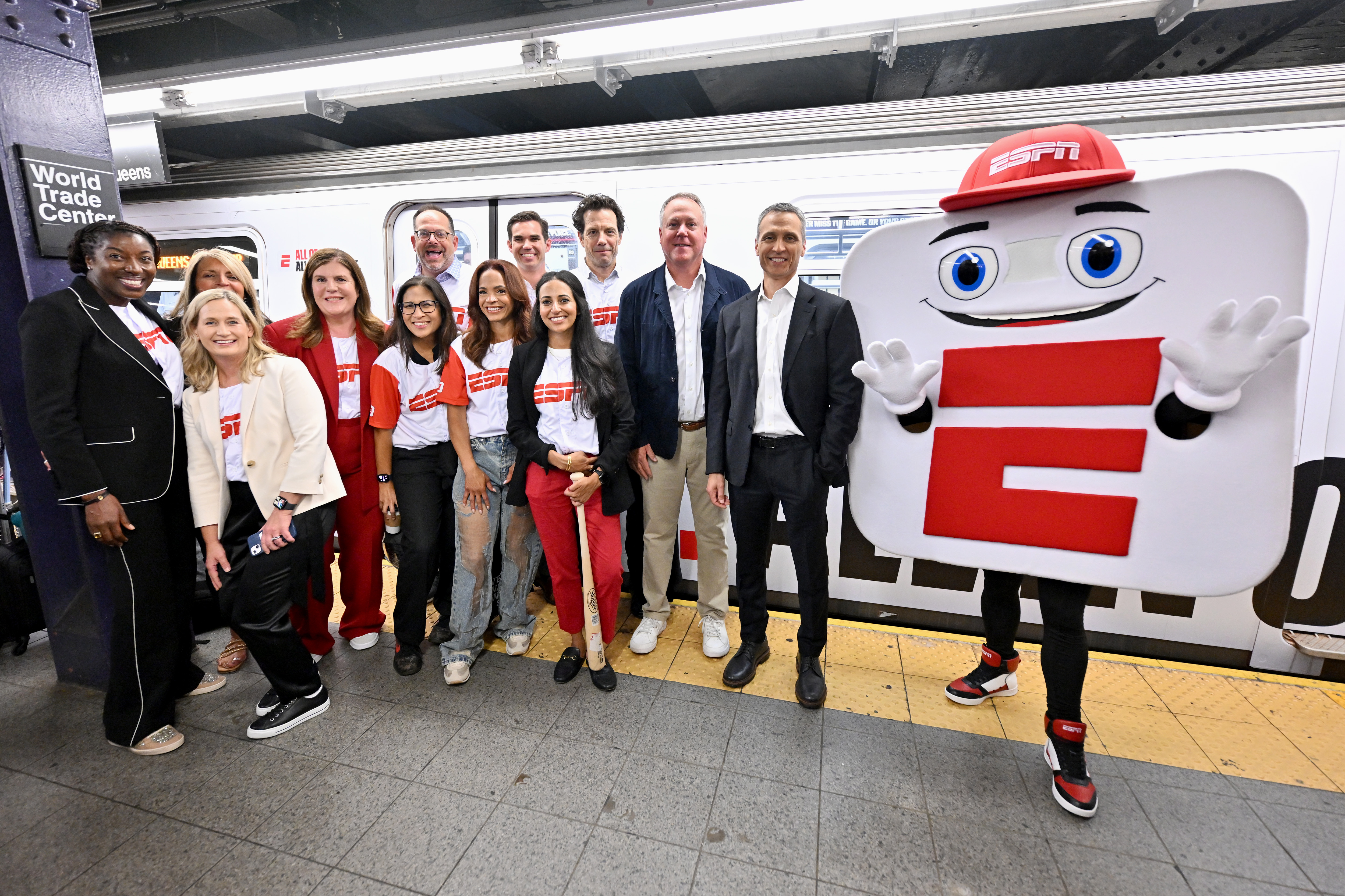 ESPN unveils revamped app with mascot takeover on New York City’s ‘E’ train 7 Rosalyn Durant, Denise Pellegrini, Tina Thornton, Rita Ferro, Judy Agay, Josh Krulewitz, Elle Duncan, Jimmy Zasowski, Chara-Lynn Aguiar, Adam Smith, Burke Magnus, ESPN Chairman Jimmy Pitaro and mascot App-E take the inaugural ride of ESPN’s "E" train takeover celebrating the launch of the new ESPN app on August 21, 2025 in New York City.