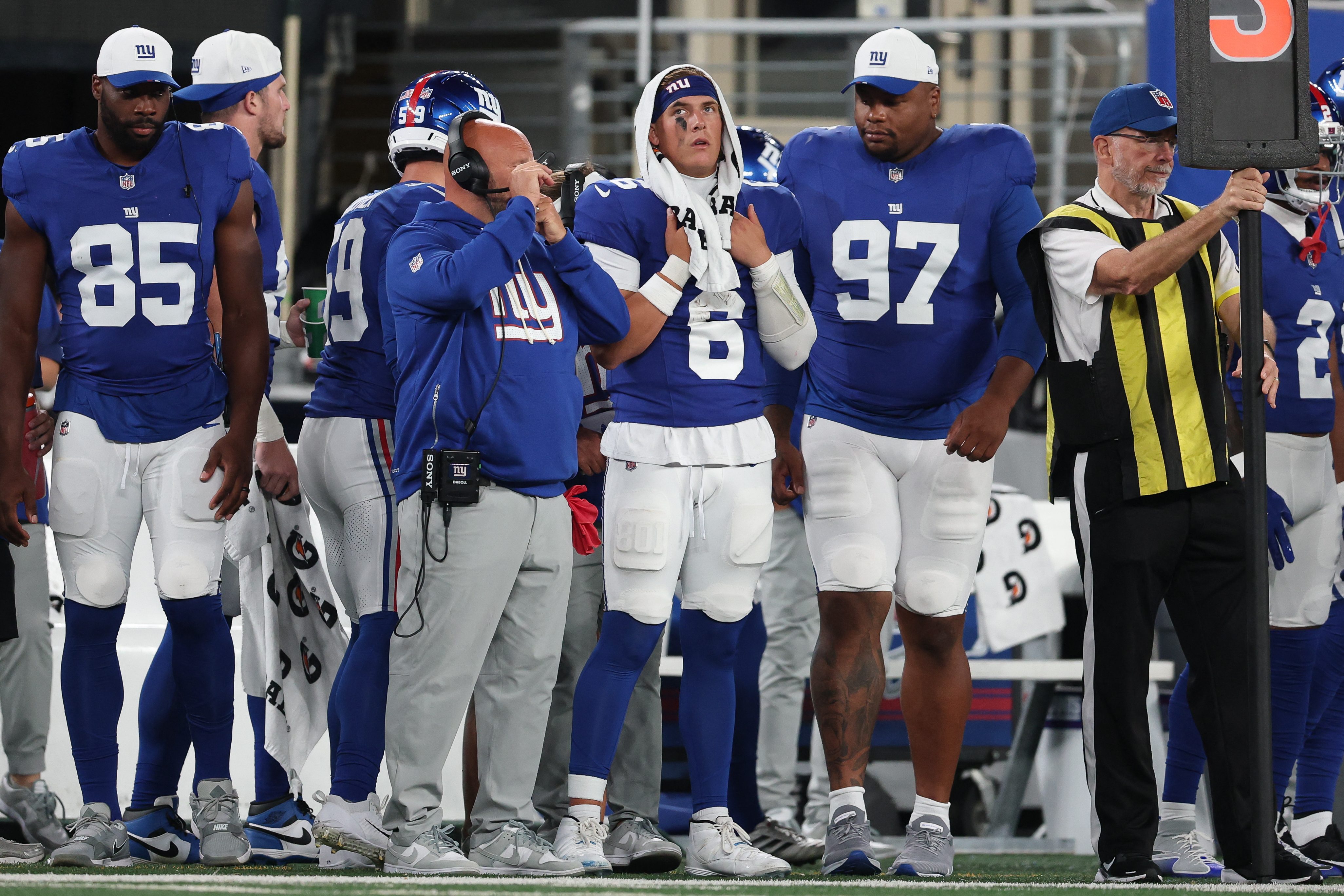 Giants' Russell Wilson keeping trademark confidence with Jaxson Dart looming 2 Jaxson Dart Giants sideline: Football player in blue uniform watches game with towel wrapped around head